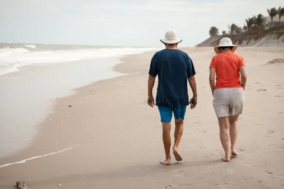 Older couple walking along the beach